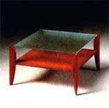 
      Tavolino in teak, piano cristallo acidato. 
      Teak-wood little table, acidified crystal top.
      cm. 80x80 h 45
      
